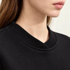 Women's oversized crew neck sweatshirt with long sleeves and small heart detail