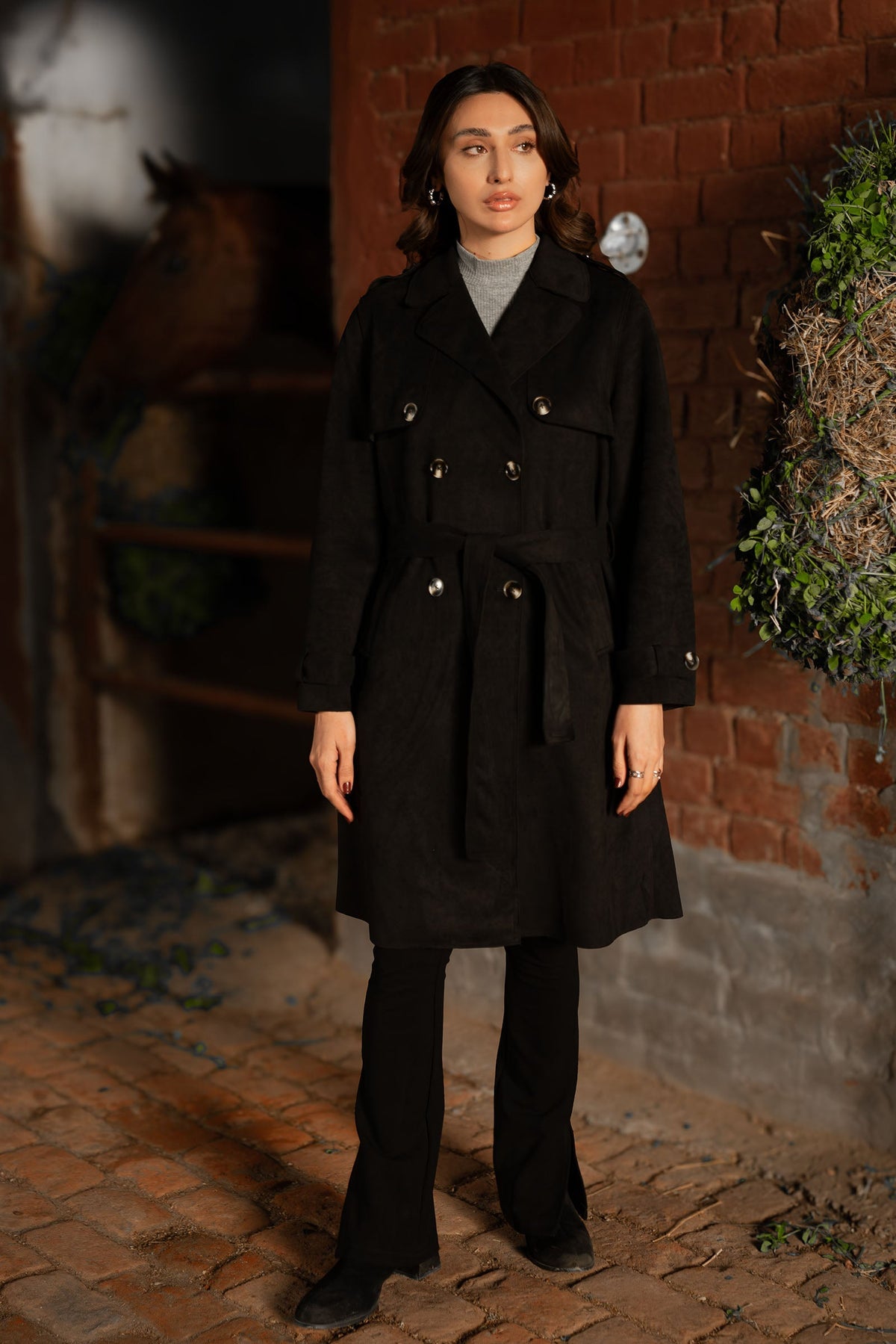 Women's black double breasted belted coat with lapels and long sleeves