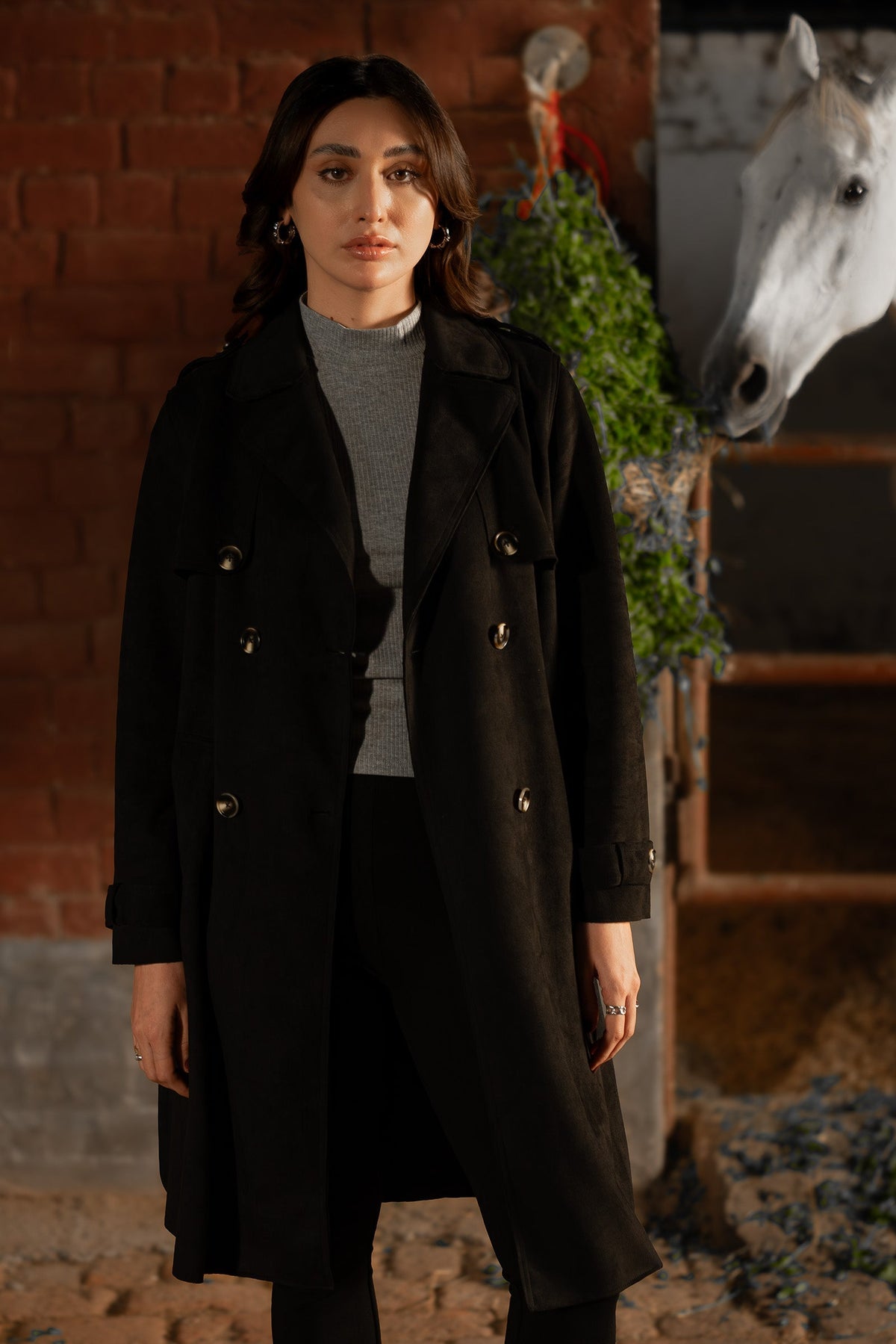 Women's black double breasted belted coat with lapels and long sleeves