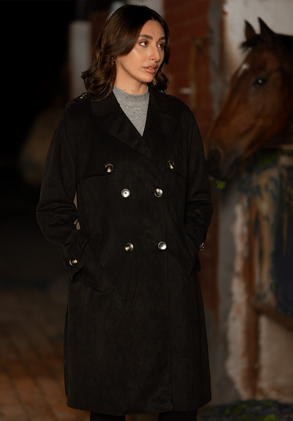 Women's black double breasted belted coat with lapels and long sleeves