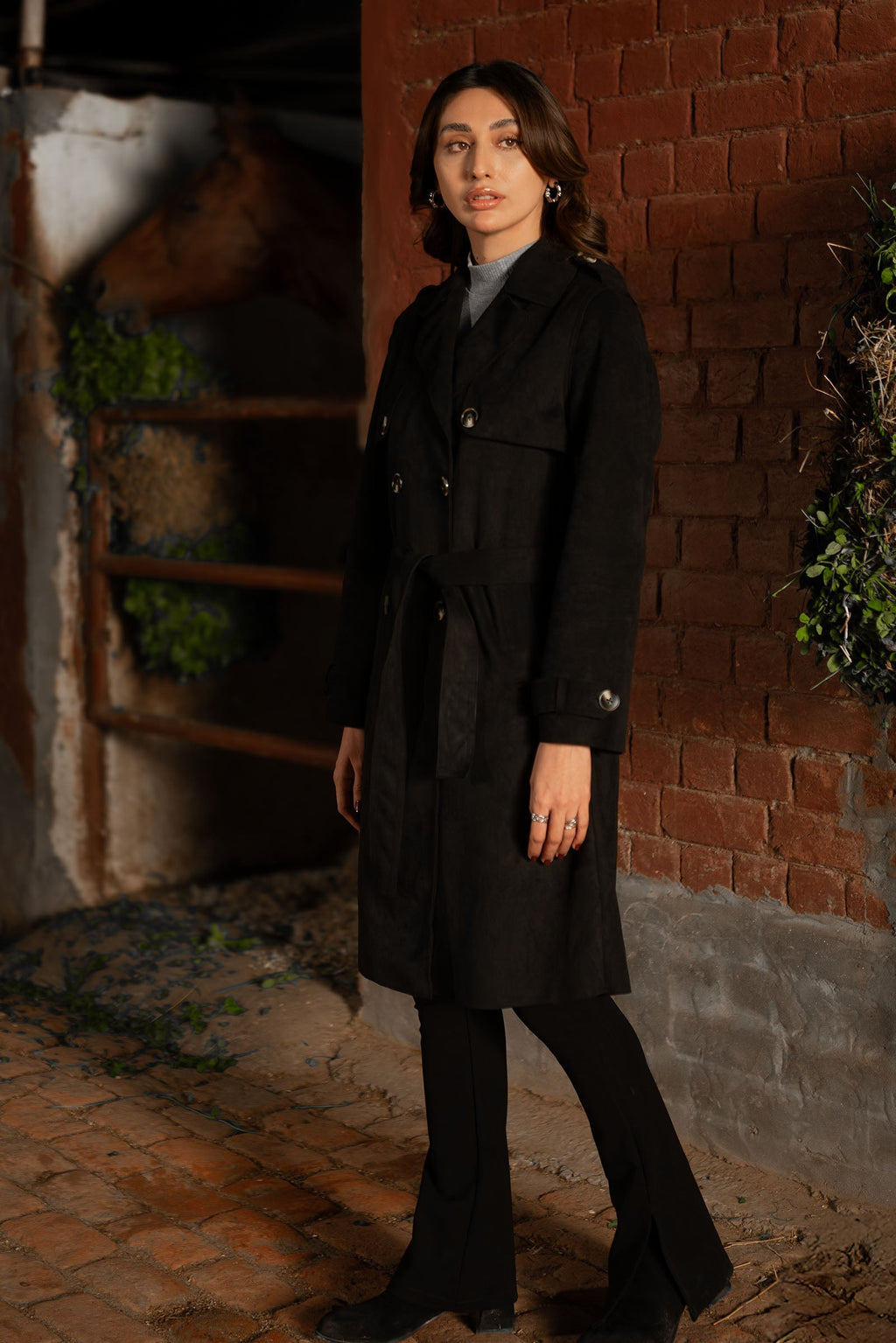 Women's black double breasted belted coat with lapels and long sleeves