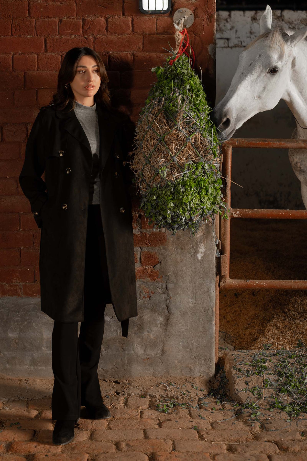 Women's black double breasted belted coat with lapels and long sleeves