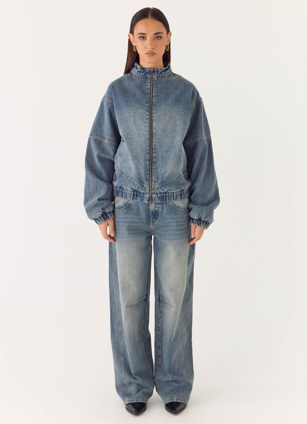 Women's blue denim bomber jacket with high collar and zip front