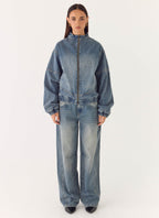 Women's blue denim bomber jacket with high collar and zip front