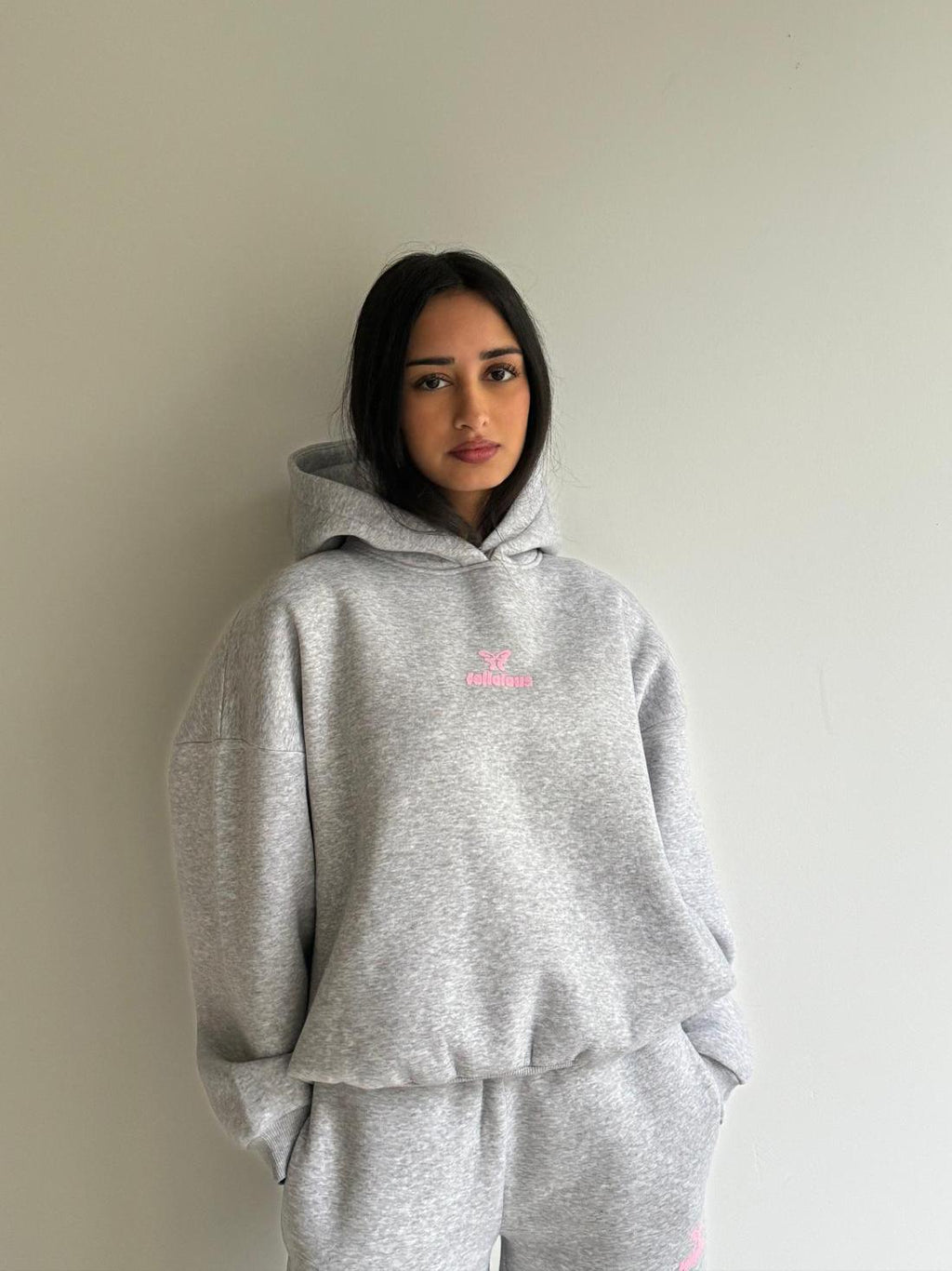 Women's light grey hooded sweatshirt with pink chest logo