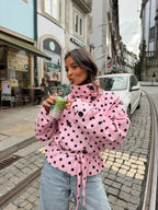 Women's pink cropped jacket with black polka dots, high collar and tie waist