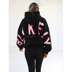 Women's hooded sweatshirt with large black graphic lettering on the back and sleeves