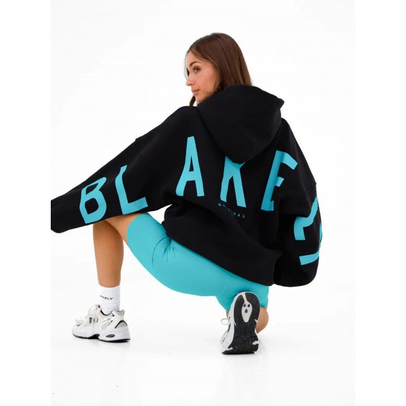 Women's hooded sweatshirt with large black graphic lettering on the back and sleeves