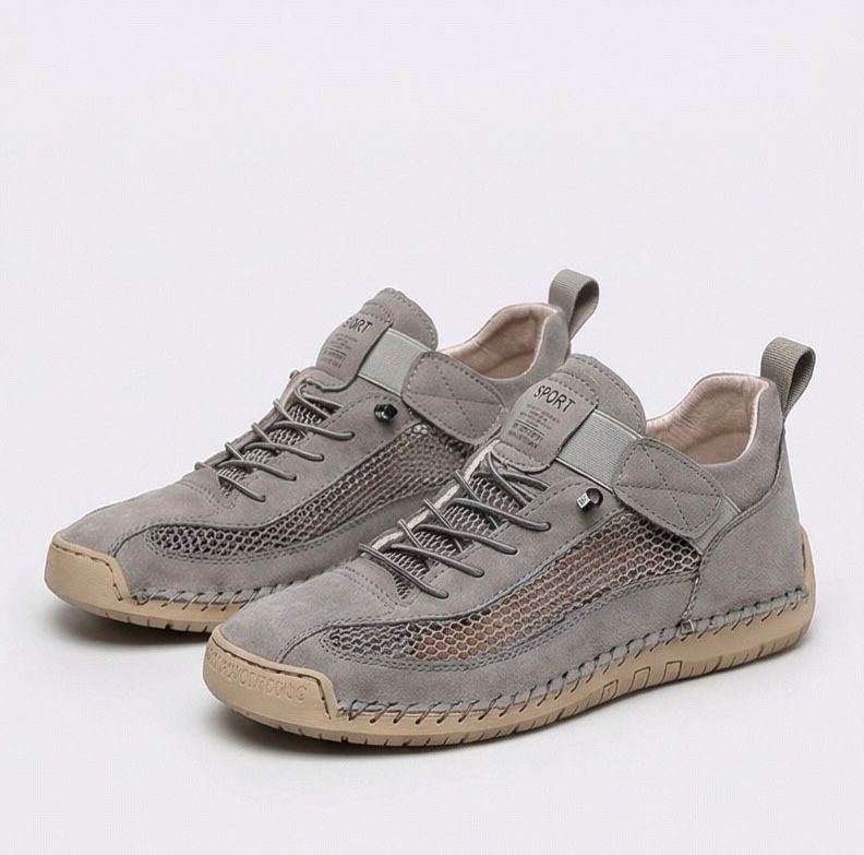 Women's lace-up trainers with mesh side panels, rounded toe and flat textured sole
