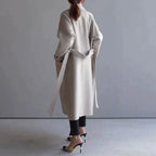 Women's long trench coat with notched lapels, buttons and side pockets