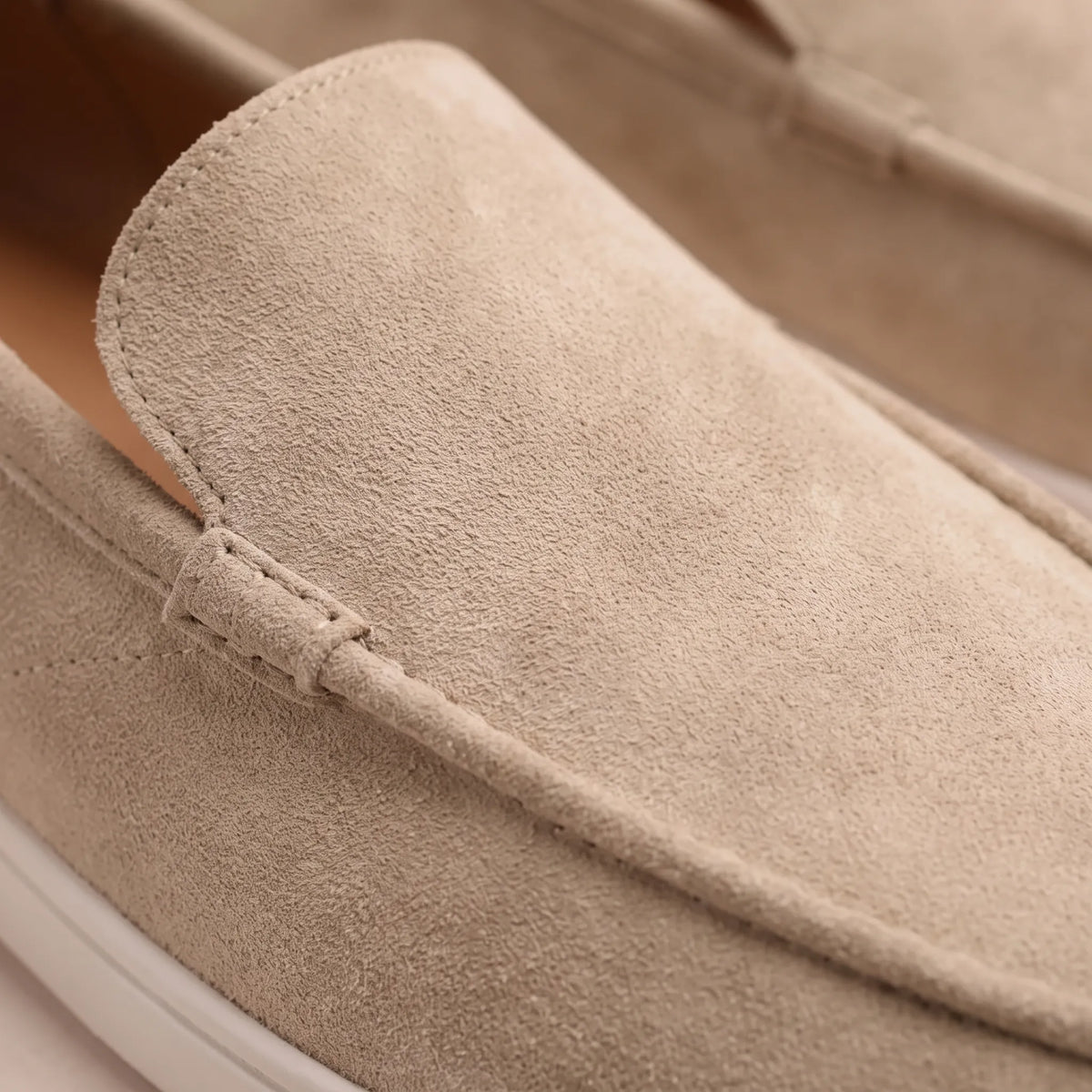 Men's slip-on loafers with rounded moc toes, stitched edging and flat soles