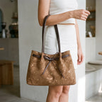 Women's flared tote bag with scattered studs, long handles and front bow tie detail
