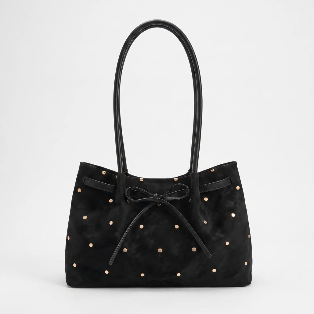 Women's flared tote bag with scattered studs, long handles and front bow tie detail