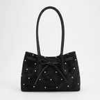 Women's flared tote bag with scattered studs, long handles and front bow tie detail