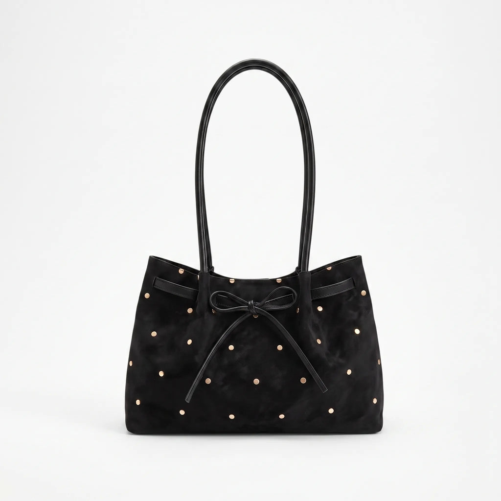 Women's flared tote bag with scattered studs, long handles and front bow tie detail