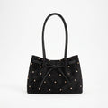 Women's flared tote bag with scattered studs, long handles and front bow tie detail