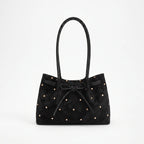 Women's flared tote bag with scattered studs, long handles and front bow tie detail