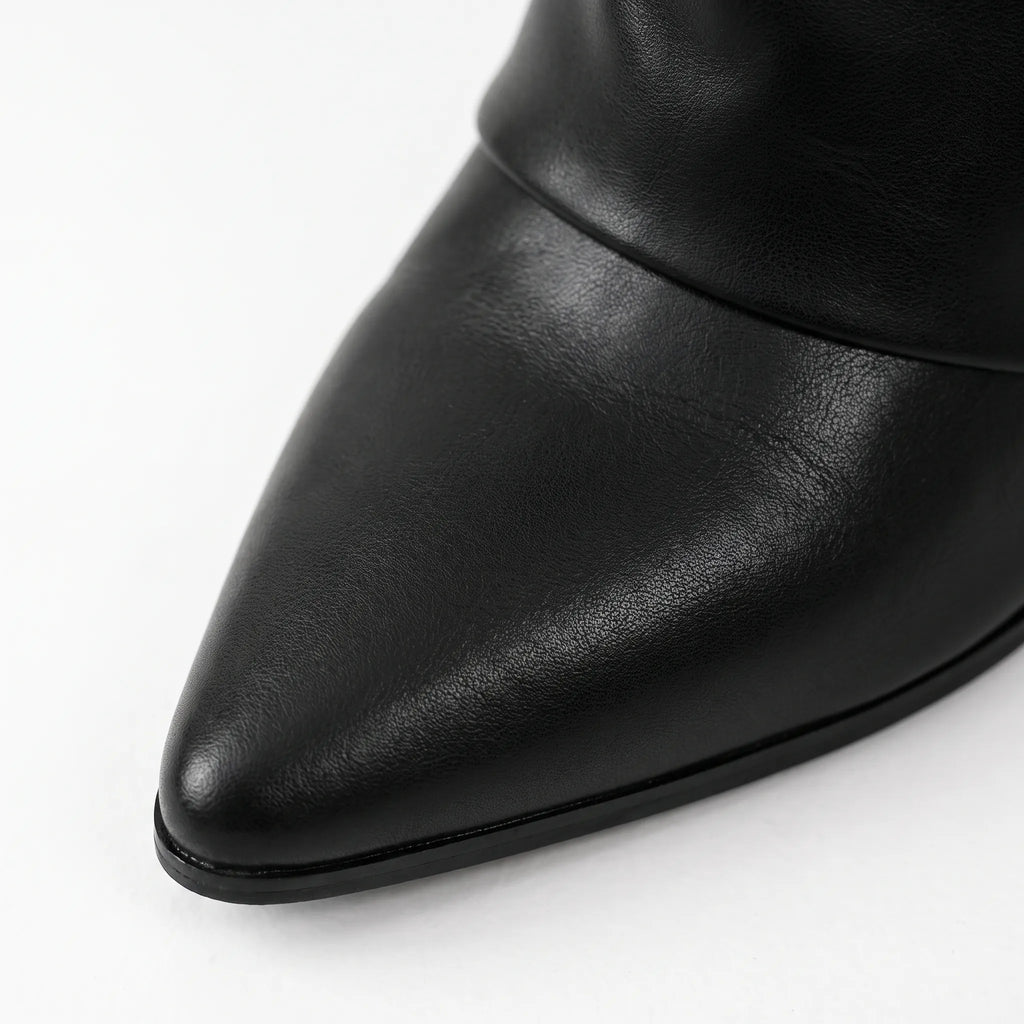 Black women's pointed toe knee high boots with buckle detail and low heels