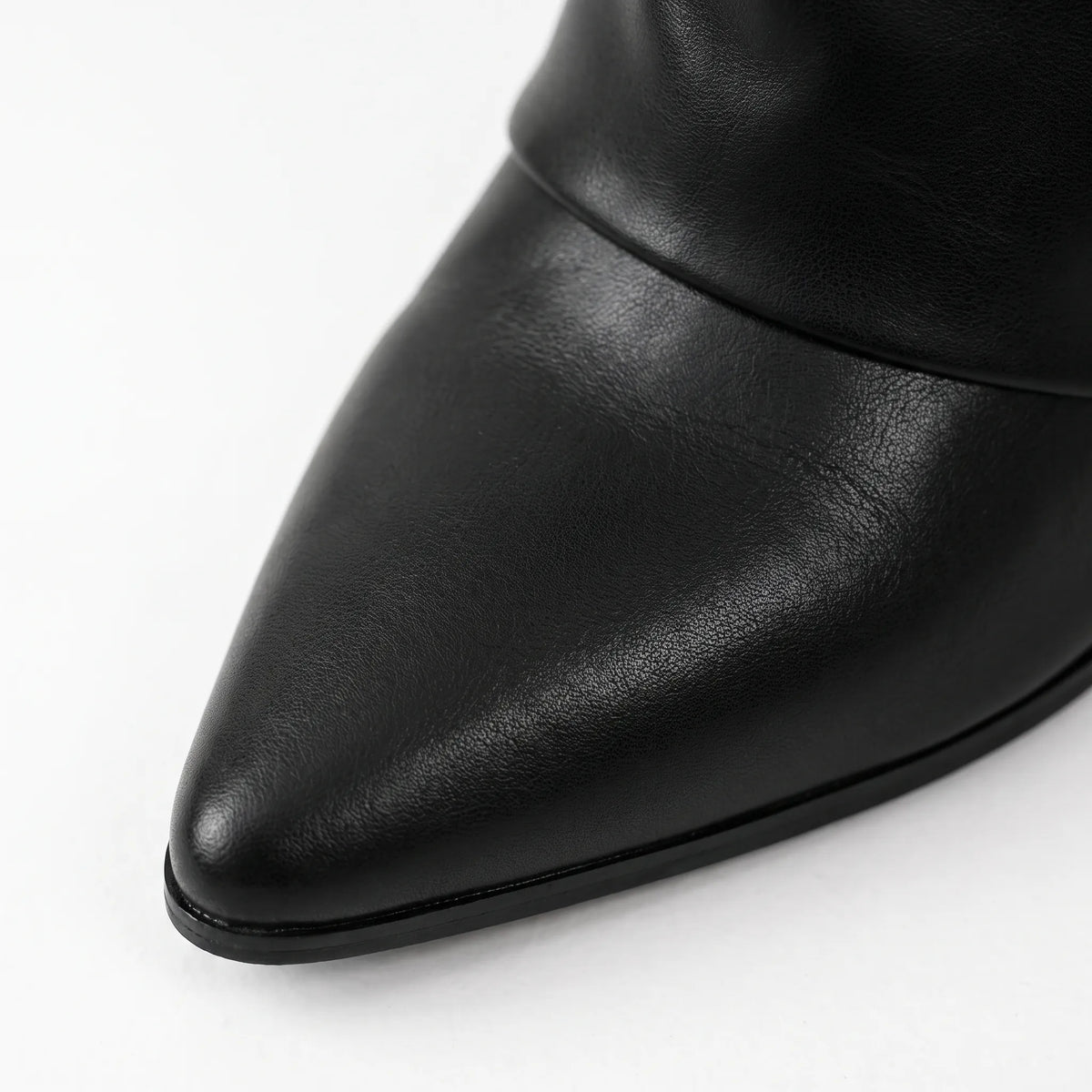 Black women's pointed toe knee high boots with buckle detail and low heels