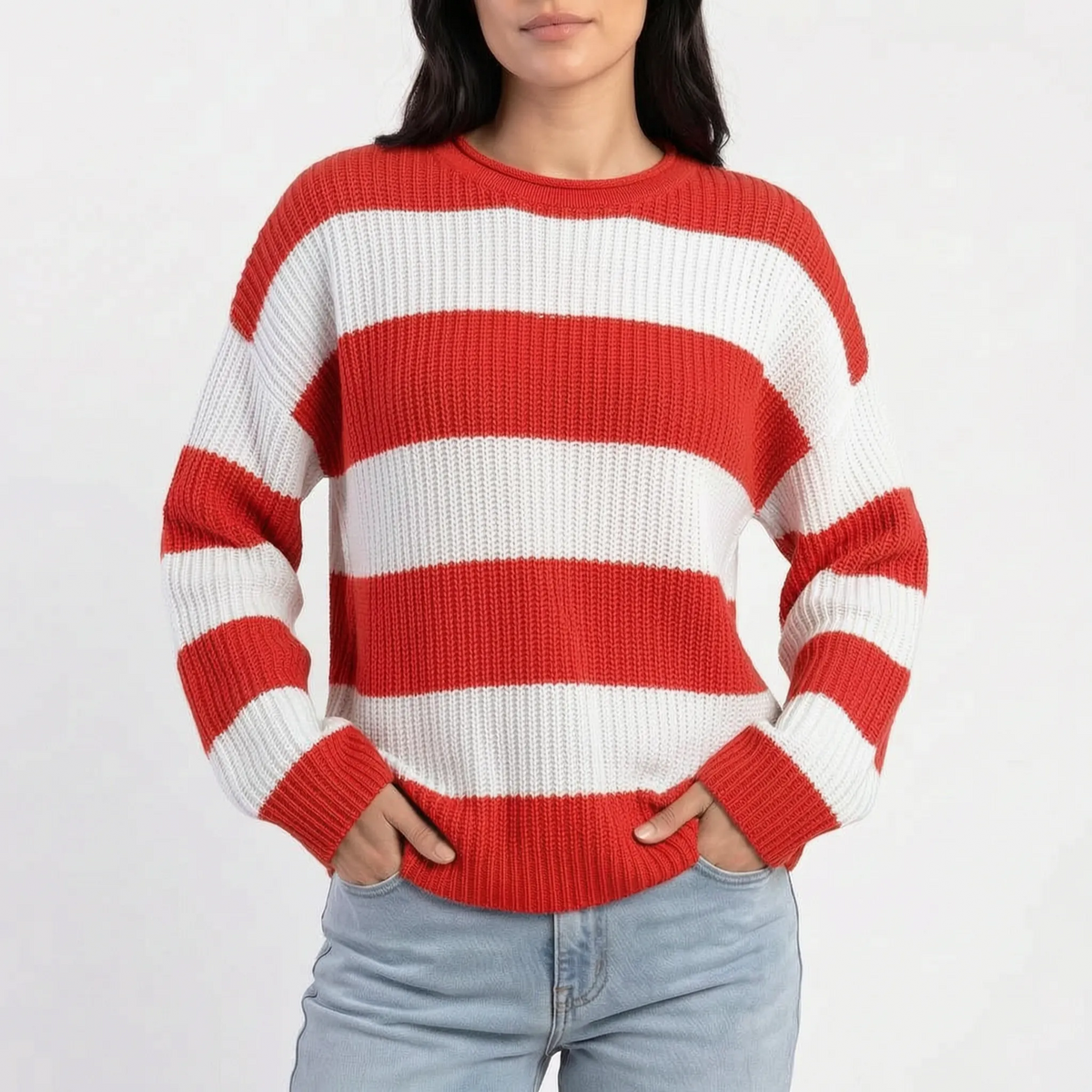Woman wearing an oversized striped knitted jumper with a crew neck and long sleeves
