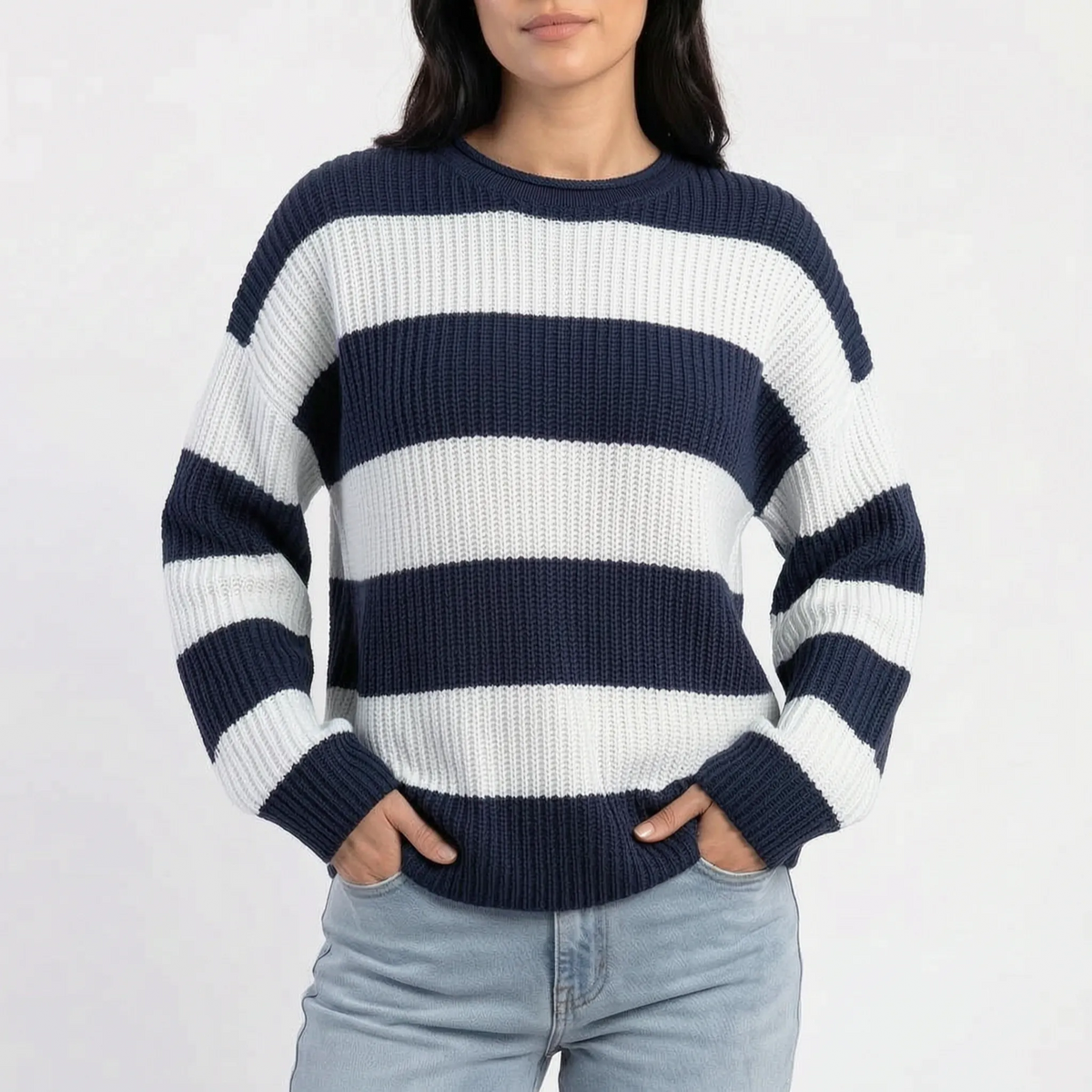 Woman wearing an oversized striped knitted jumper with a crew neck and long sleeves