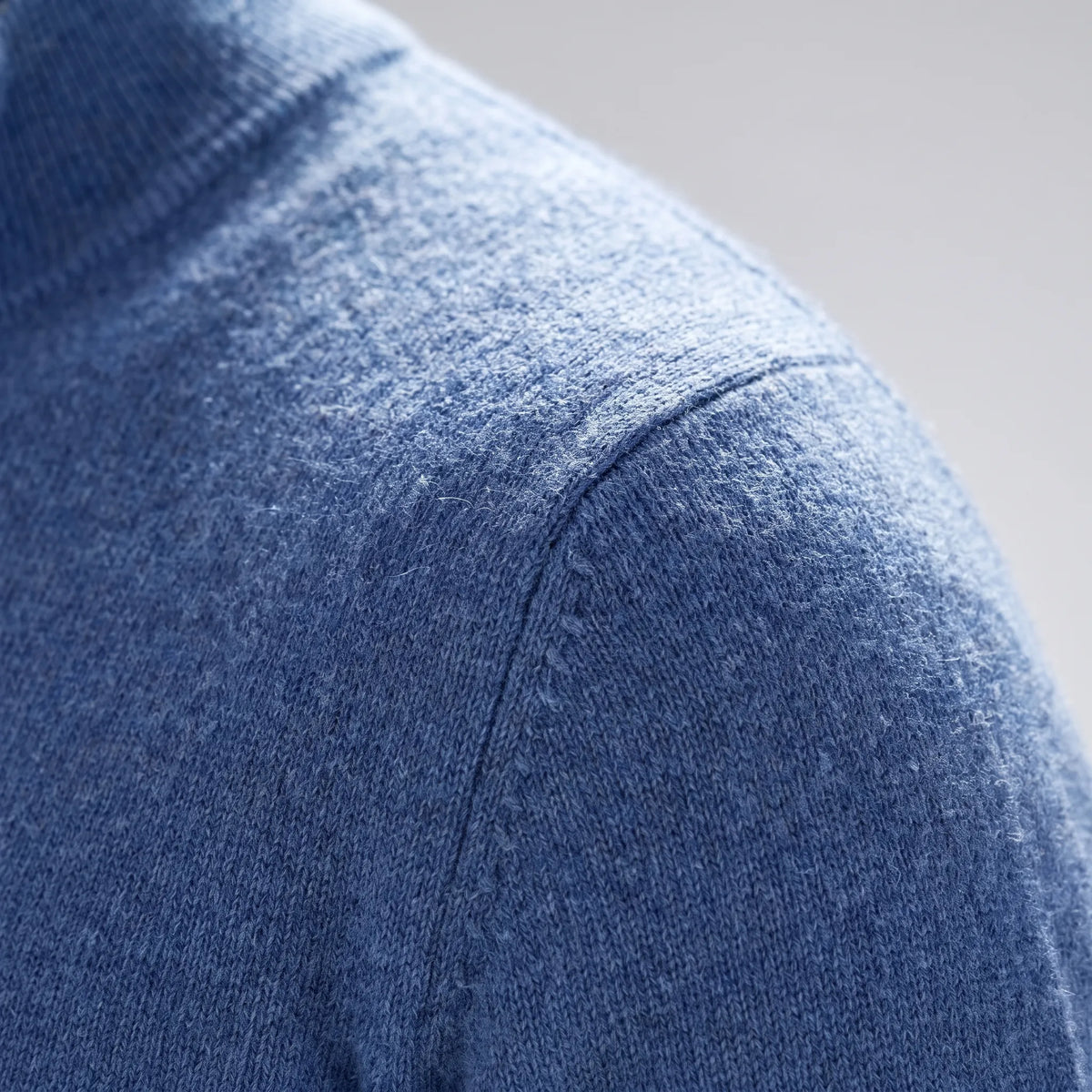 Men's blue quarter zip knit jumper with stand collar and long sleeves