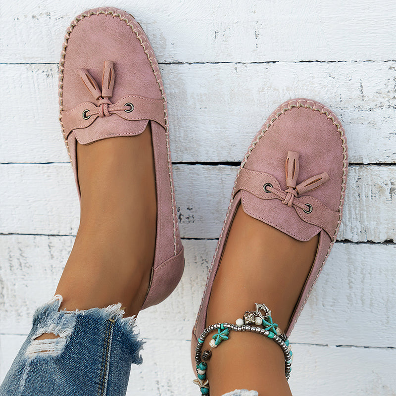 Women's flat loafers with round toes, stitched edging and bow details