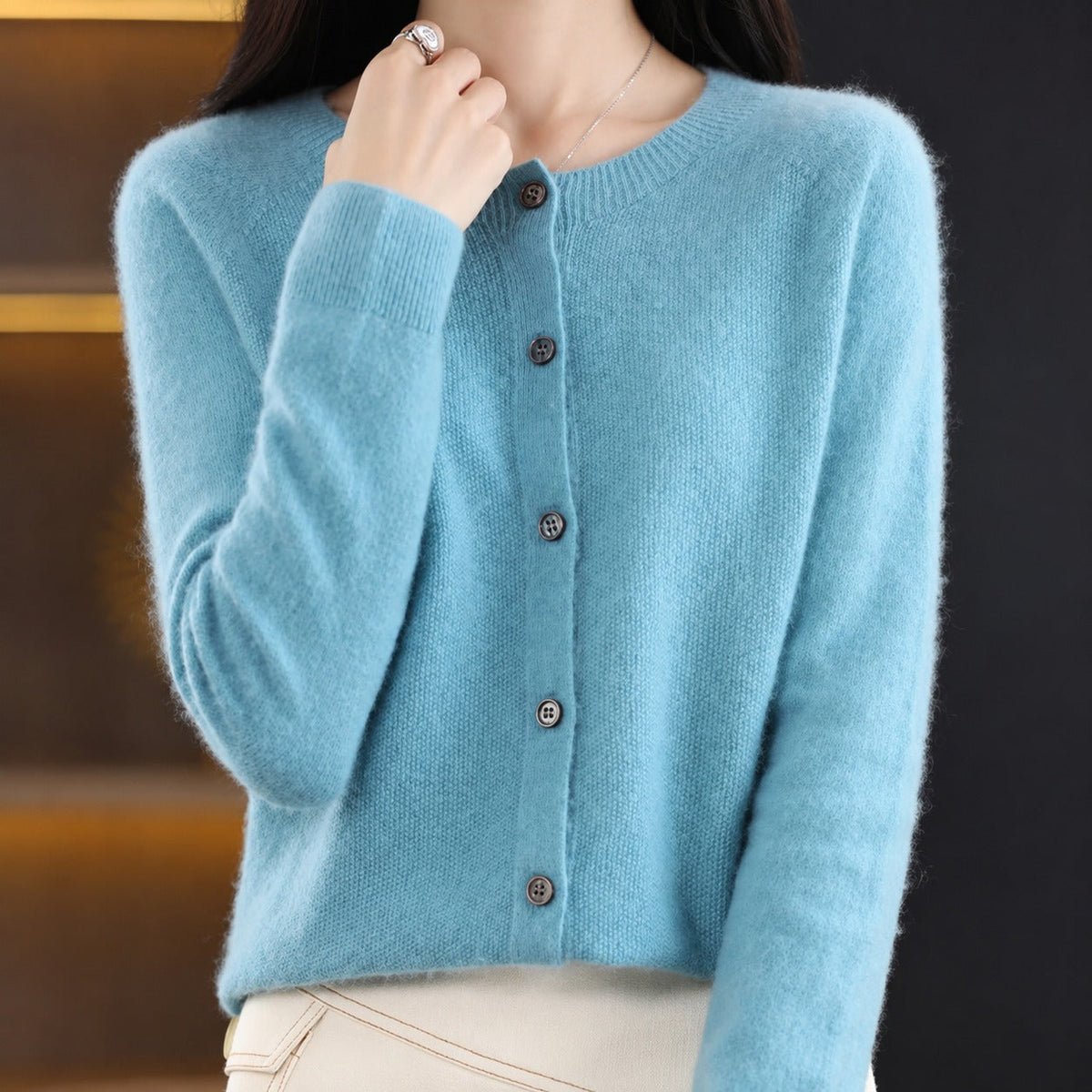 Women's plain knitted button-front cardigan with crew neckline and long sleeves
