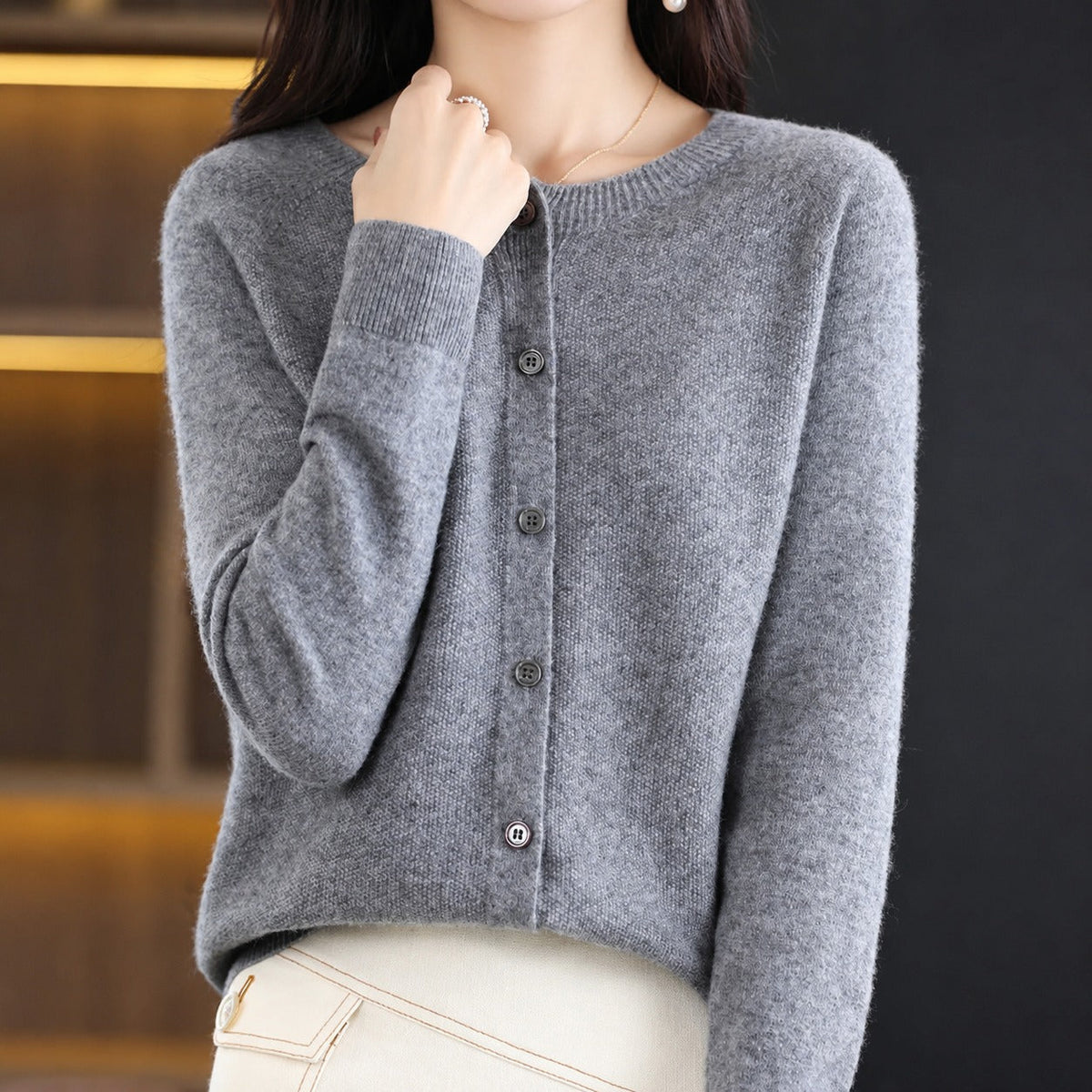 Women's plain knitted button-front cardigan with crew neckline and long sleeves