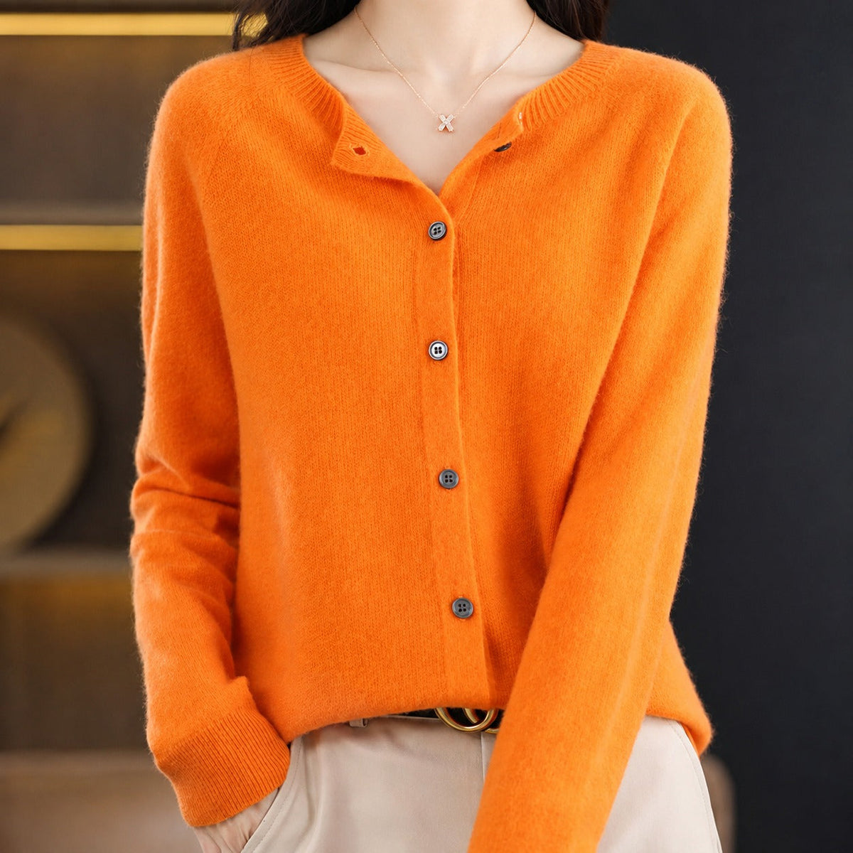 Women's plain knitted button-front cardigan with crew neckline and long sleeves