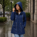 Women's hooded rain jacket with long sleeves, zip front and drawcord pockets
