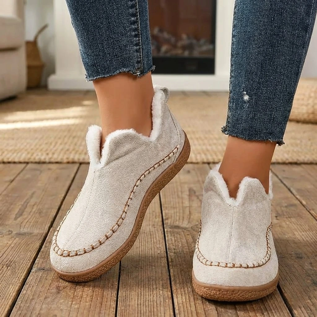 Women's slip-on loafers with moc toe stitching, plush trim and flat textured soles