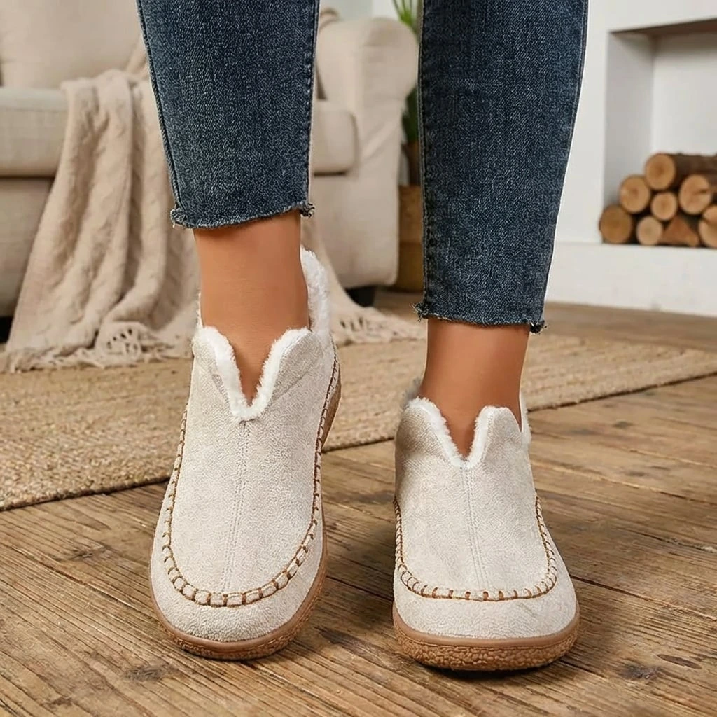Women's slip-on loafers with moc toe stitching, plush trim and flat textured soles