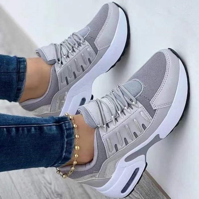Women's low-top lace-up trainers with textured panels and chunky soles