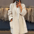 Women's longline textured knitted cardigan with open front, long sleeves and two front pockets