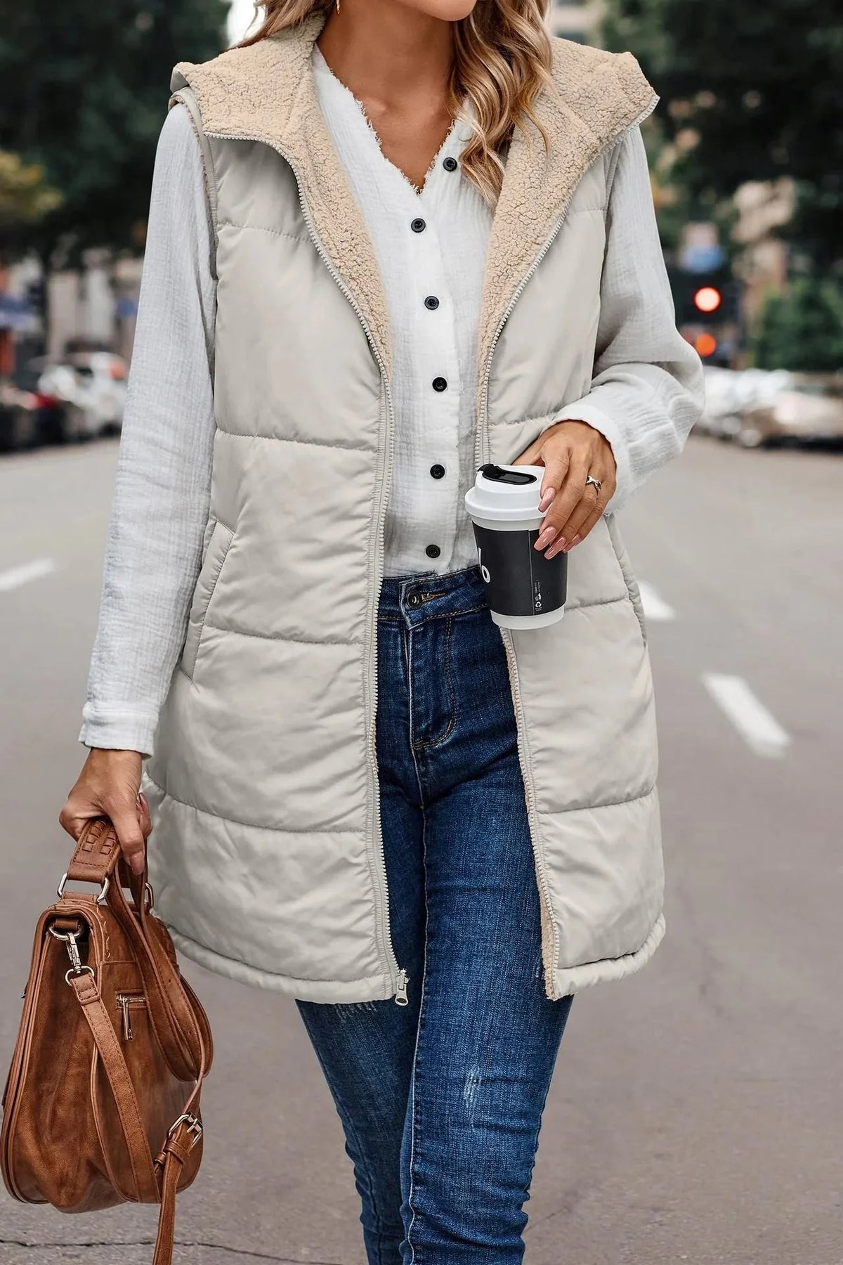 Women's longline quilted hooded puffer vest with zip fastening