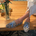 Women's beige animal print loafers with blue tassel details