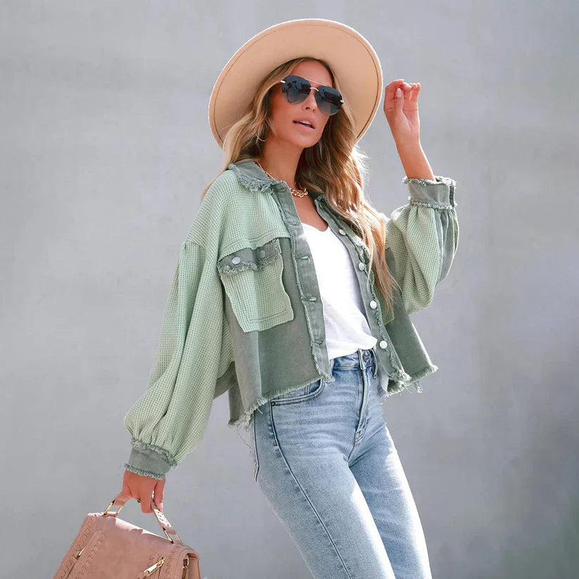 Women's cropped utility jacket with long sleeves, chest pockets and frayed trims