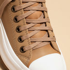 Women's platform lace-up sneakers with chunky ridged soles in beige and tiger stripe designs