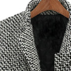 Women's long black and white herringbone coat with notched collar and button fastening