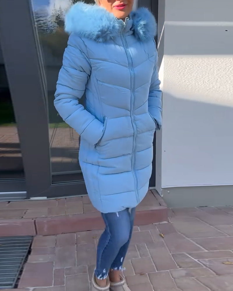 Women's blue quilted hooded coat with fluffy trim and zipped pockets