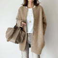 Women's relaxed fit long coat with round neck, long sleeves and snap buttons