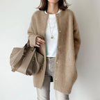 Women's relaxed fit long coat with round neck, long sleeves and snap buttons