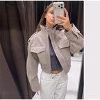 Women's grey cropped bomber jacket with mock neck and flap pockets