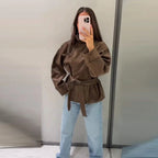 Women's brown belted jacket with high collar, long sleeves and button cuffs