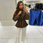Women's brown belted jacket with high collar, long sleeves and button cuffs