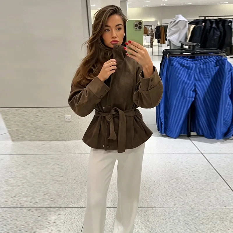 Women's brown belted jacket with high collar, long sleeves and button cuffs