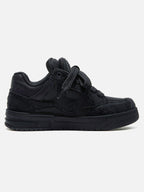 Black high-top skate sneakers with tonal camouflage side panels and lace-up fronts