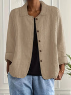 Women's button-front collared cardigan with long sleeves and rounded hem