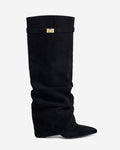 Women's black slouchy knee-high boots with pointed toes and buckle strap details